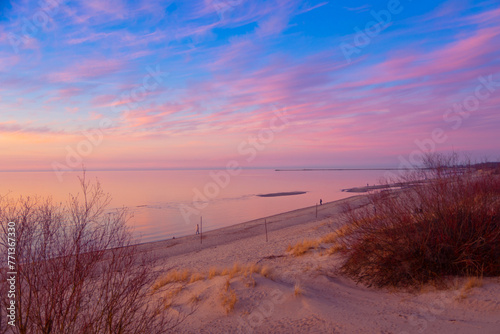 A beautiful spring sunset landscape of a Baltic Sea beach in Riga, Latvia. Colorful evening scenery of Northern Europe.
