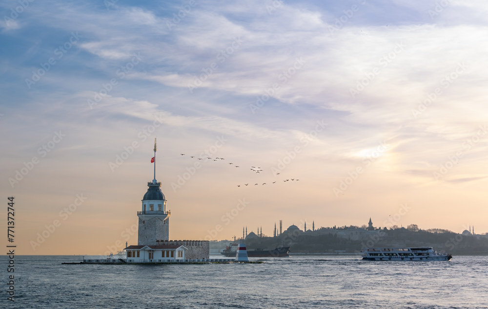 Beautiful sunset over Bosphorus with famous Maiden's Tower (Kiz Kulesi) also known as Leander's Tower, symbol of Istanbul, Turkey. Scenic travel background.