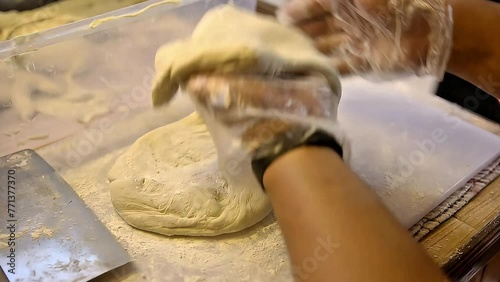 The cakwe dough is given flour while pressing it, Street Food photo