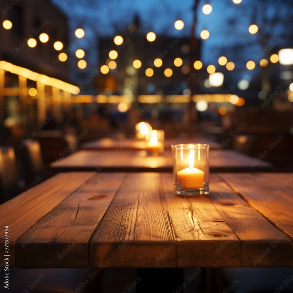 An empty restaurant with a candle on a wooden table