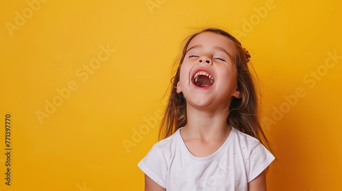 A sweet young girl singing happily against a bright yellow background with ample copy space