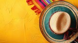 a colorful Mexican sombrero with a colorful striped blanket and a red