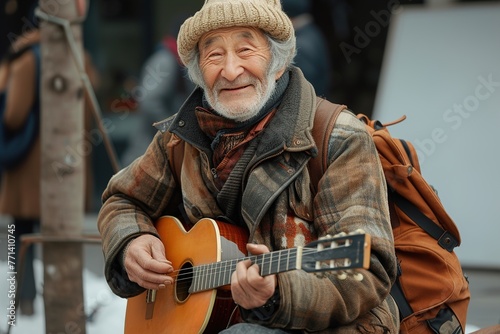 A man with a beard and a hat is smiling while holding a guitar