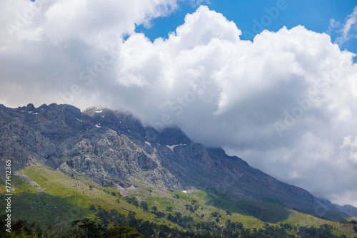 Mountains in the clouds. View of the mountain peak in the fog. Beautiful landscape with high cliffs. Dedegol. Turkey.