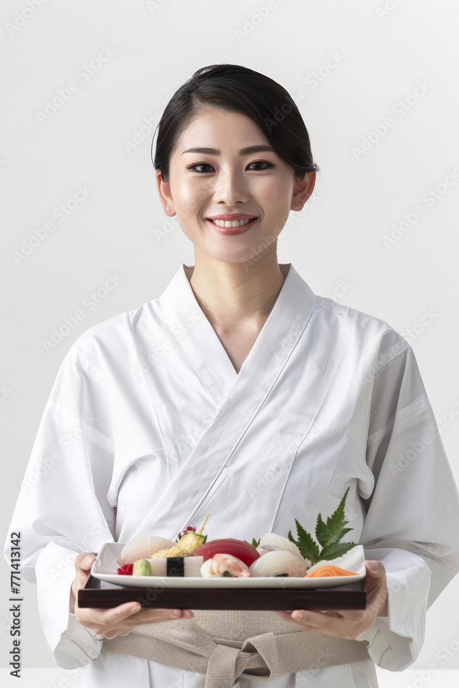 A woman dressed in a traditional kimono is holding a plate of Sushi
