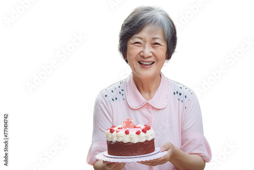 Middle aged Chinese woman on isolated chroma key background holding cake