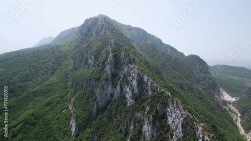 Bovilla lake, Tirana, Albania. Aerial cinematic view of Mount Dajt National Park. Slow drone travelling above the mountains and forest in famous landmark tourist destination of Balkans photo