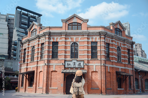 Asian woman walking around the city Relaxed female traveler tours the theater Red house in Ximending landmark Popular tourist attractions in Taipei, Taiwan photo