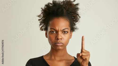 Angry Black Woman Making A Disapproving Gesture With Her Finger. Conveying a Sense of Disagreement or Refusal © Immersive Dimension