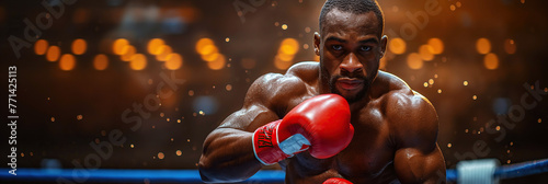 black man boxer in red gloves punching in boxing ring on background close up
