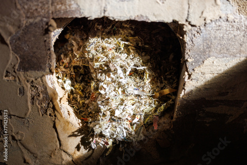 Close up of a mouse nest in a fireplace chimney. Selective focus, background blur and foreground blur.
