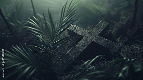 A cross is on a forest floor. The cross is surrounded by green leaves and moss.