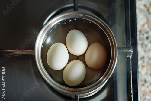 Saucepan with boiling eggs on gas stove