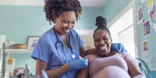 A nurse conducting a prenatal check-up on a pregnant woman.  photo