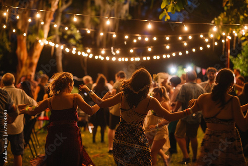 People dancing at a concert, absorbed in the rhythm and euphoria of a live music festival under the stars.