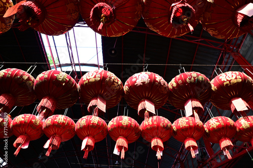 BANGKOK, THAILAND - March 30, 2024: Chinese Paper Lanterns hanging on a rope New Year Festival at Dragon Temple Kammalawat or Wat Lengnoeiyi is a chinese temple in Thailand photo