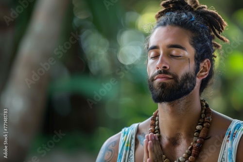 Man meditating with hands in prayer