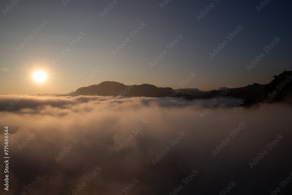 The landscape from the top of the mountain, high above the clouds and thick, white mist. There is a morning sun. clear sky on the mountain Looking out, feeling amazing