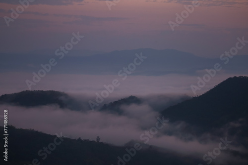 Background image of a morning landscape on a mountaintop with mountains and a sea of ​​mist before the sun rises. There is space for text. © Core