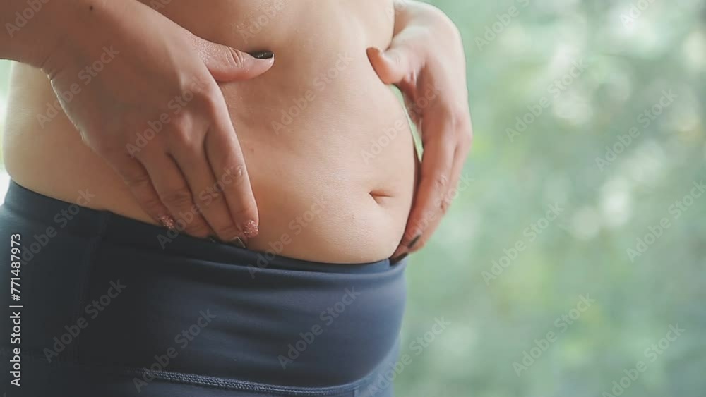 Women body fat belly. Obese woman hand holding excessive belly fat. diet lifestyle concept to reduce belly and shape up healthy stomach muscle. Women body fat belly. Obese woman hand holding excessive belly fat. diet lifestyle concept to reduce belly and shape up healthy stomach muscle.