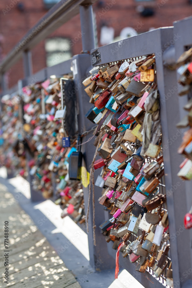 Obraz premium Love lock bridge at Katajanokka with bunch of locks. Couples putting locks on bridges. Bridge full of locks. Vertical photos.