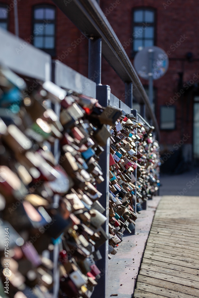 Obraz premium Love lock bridge at Katajanokka with bunch of locks. Couples putting locks on bridges. Bridge full of locks. Vertical photos.