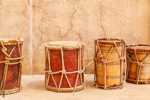 Vintage wooden drums over old wall background. Traditional mediterranean musical instrument