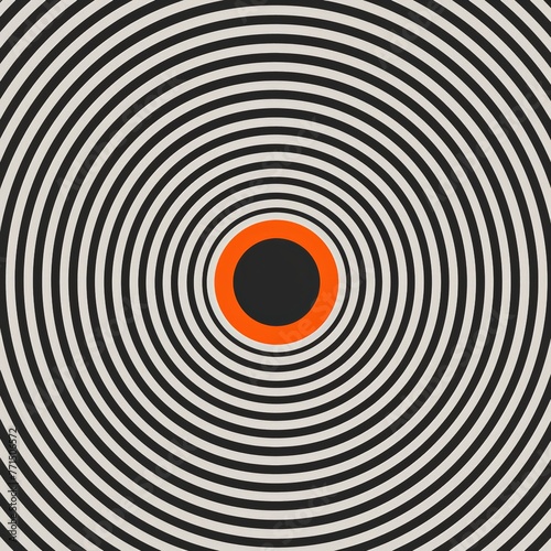 A circular object featuring alternating black and white sections with a vibrant orange center