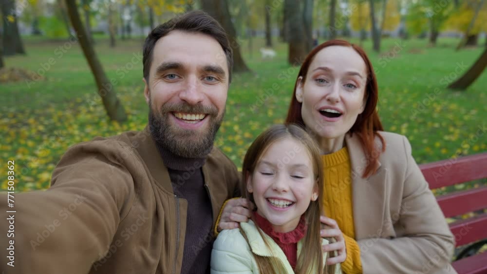 Happy Caucasian smiling talking at mobile phone webcam web camera family joyful smile mother father little child kid girl daughter in autumn park city bench talk video call conference blog make selfie Happy Caucasian smiling talking at mobile phone webcam web camera family joyful smile mother father little child kid girl daughter in autumn park city bench talk video call conference blog make selfie