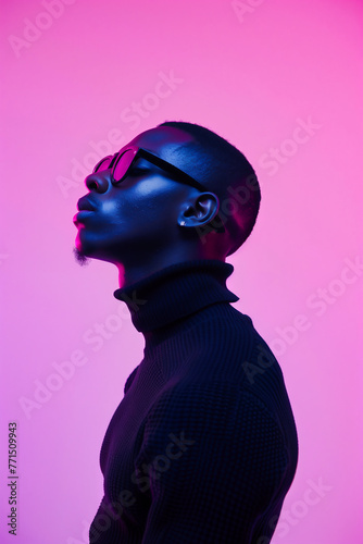 Young african american man in sunglasses and black sweater isolated on pink background.
