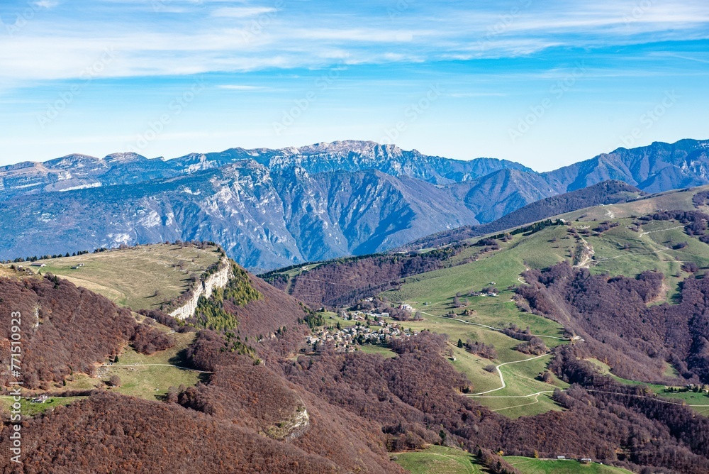 Naklejka premium a view from the top of the mountains with green fields, grass and brown dirt