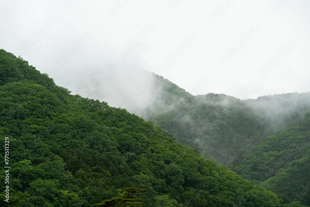 Picturesque view of lush, green hills surrounded by clouds