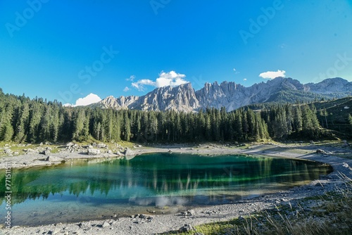 Expansive mountainous landscape with lush evergreen trees and a tranquil lake
