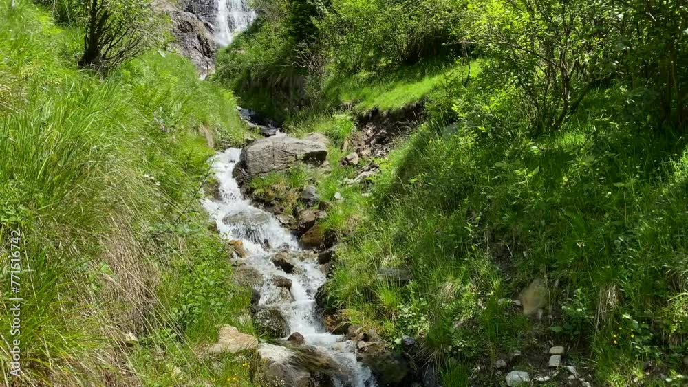 Beautiful view of a waterfall coming out from a forested mountain Beautiful view of a waterfall coming out from a forested mountain