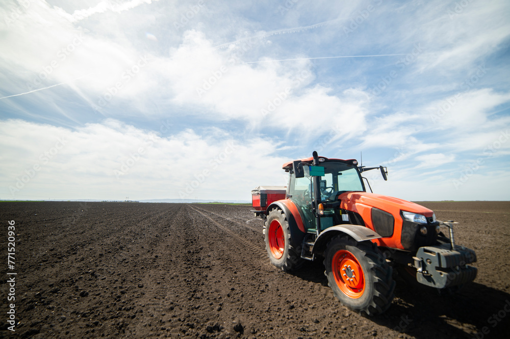 Tractor spreading artificial fertilizers