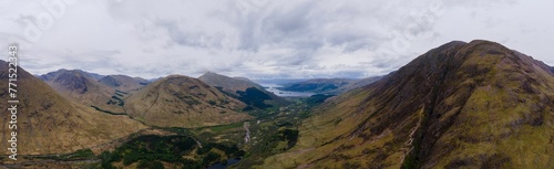 Panoramic view of a mountain valley on a cloudy day  with lush  green hillsides