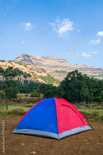 Beautiful landscape of camp and tents with hills at Arthur Lake in Bhandardara in Maharashtra, India
