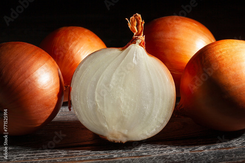 sliced onions on black wood background © bergamont