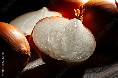 sliced onions on black wood background © bergamont