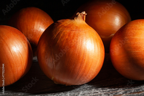 onions on black wood background © bergamont