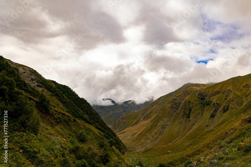 Stunning mountain range with rolling hills and lush green grass carpeting the landscape  Georgia