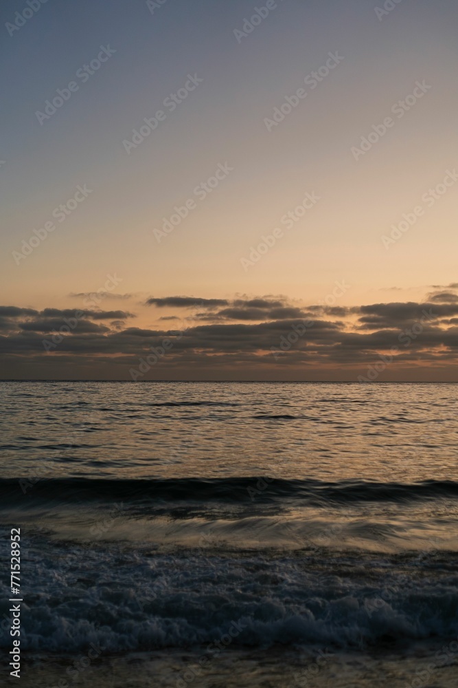 Stunning sunset shines over a peaceful ocean.