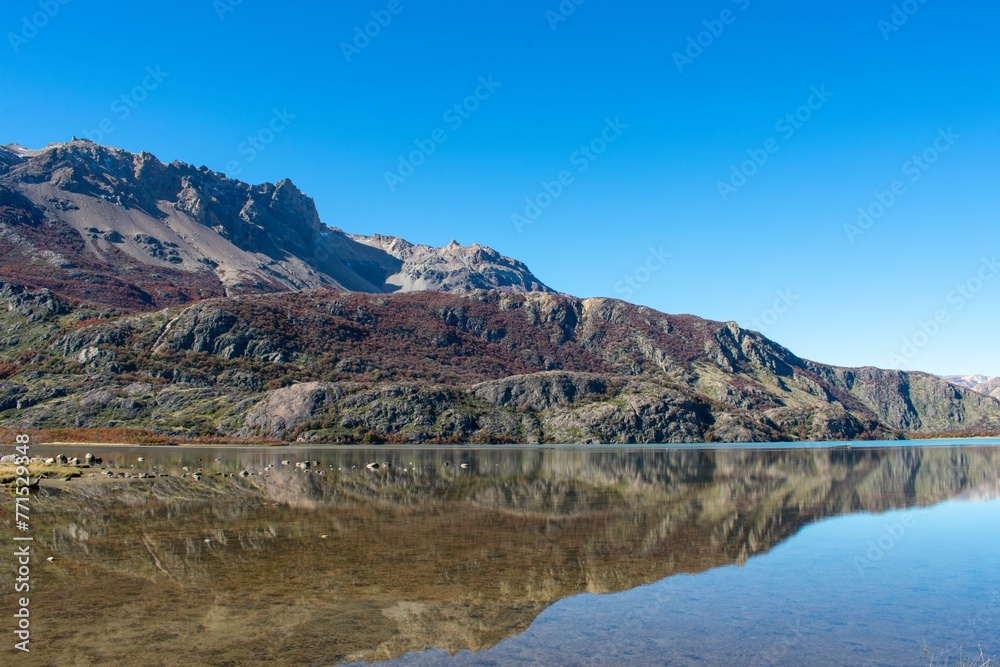 Idyllic landscape featuring a picturesque mountain range reflected in a peaceful body of water