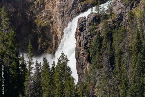 A cascading waterfall gliding across a mountainous terrain at a rapid pace
