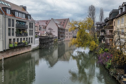 Scenic view of old buildings reflecting in a river on a cloudy day in Nuremberg, Germany