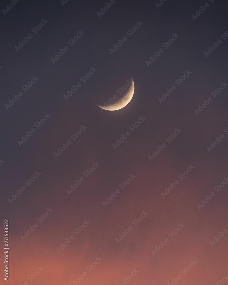 Vertical of the moon in the sky at sunset Vertical of the moon in the sky at sunset