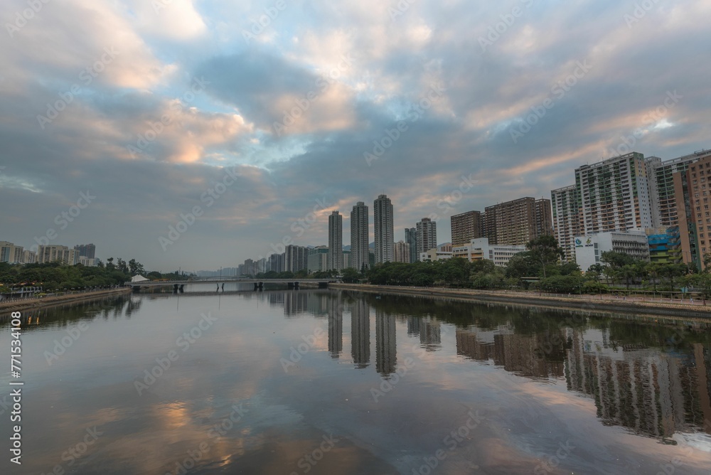 Cloudy sky over the Shatin Shing Mun River and buildings at sunrise