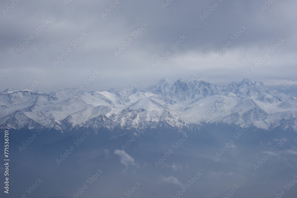 Gorgeous view of clouds floating above the Ten-Zan Bogda peak