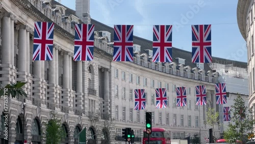 Panoramic view of Regent road street in central London with British flags handing along the street on sunny summer day