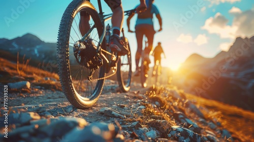 Low angle view of cross country bikers traveling in mountain landscape at sunset